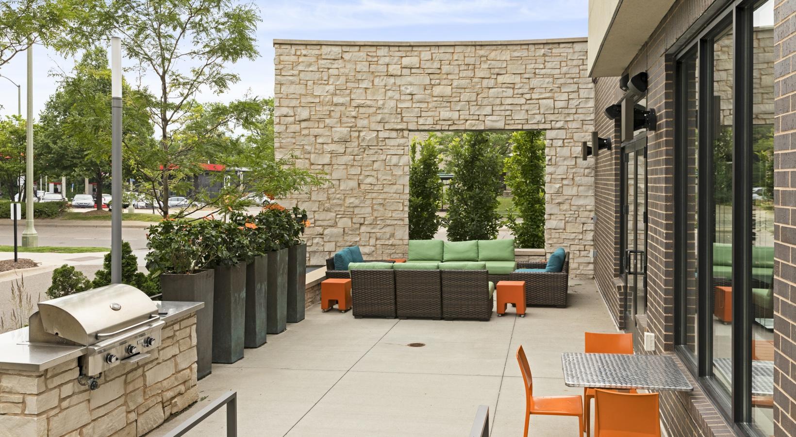 Settle into comfort at Ellipse on Excelsior a patio with tables and chairs