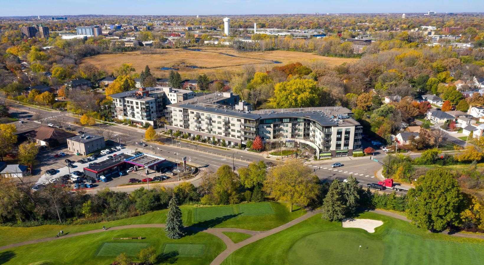 Find your perfect fit at Ellipse on Excelsior a large building with a lawn and trees in front of it